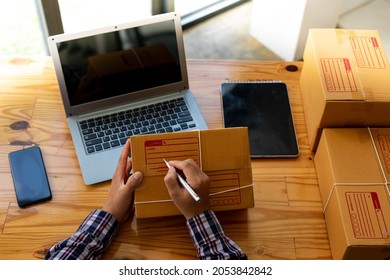 Starting Small Businesses SME Owners Man Entrepreneurs Working, Box And Check Online Orders To Prepare To Pack The Boxes, Sell To Customers, Sme Business Ideas Online.