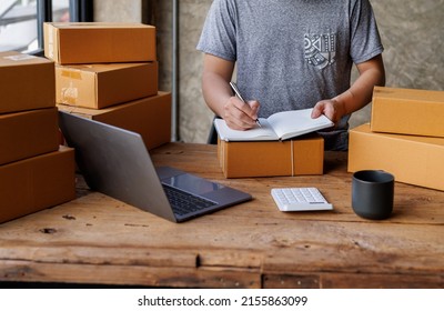 Starting Small Businesses SME Owners Man Entrepreneurs Working, Box And Check Online Orders To Prepare To Pack The Boxes, Sell To Customers, Sme Business Ideas Online.