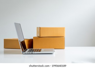 Starting small Equipments for SME online business , delivery business laptop, barcode, boxes, checking product on stocks or parcels. Small business working at home office.