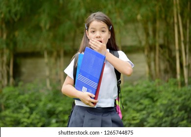 Startled Catholic Minority School Girl Wearing Uniform With Books