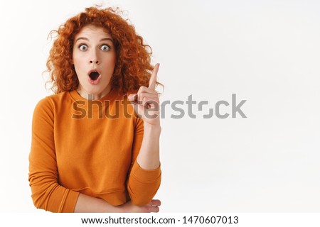 Startled excited redhead gorgeous woman have excellent idea, female coworker sharing thoughts with team, gasping open mouth, got breathtaking plan, raise finger eureka gesture