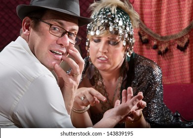 Startled Male With Gypsy Palm Reader Holding His Hand