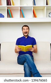 Startled Man Holding The Book And Screaming