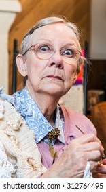 Startled Old Woman With Crochet In Livingroom