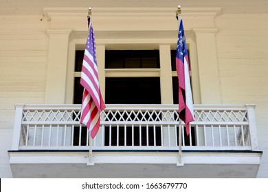 Starts And Stripes Hanging On The Balcony Of An Antebellum House