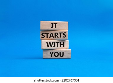 It starts with you symbol. Wooden blocks with words It starts with you. Beautiful blue background. Business and It starts with you concept. Copy space. - Shutterstock ID 2202767301