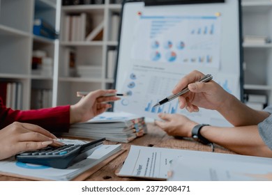 startup business, business advisor explaining strategy for planning finance investment teamwork paperwork audit and discussing marketing, profit, budget of company in meeting room - Shutterstock ID 2372908471