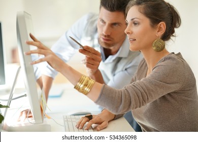 Startup Business Partners Working Together In Desktop