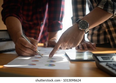 Startup business people group meeting. People group sitting on conference together and making notes. hands pointing at business document during discussion at meeting. - Shutterstock ID 1013098624