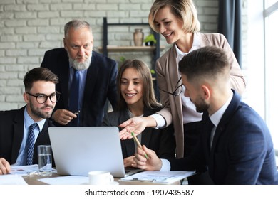 Startup Business Team On Meeting In Modern Bright Office Interior And Working On Laptop