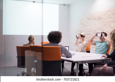 startup Business team using virtual reality headset in night office meeting  Developers meeting with virtual reality simulator around table in creative office.