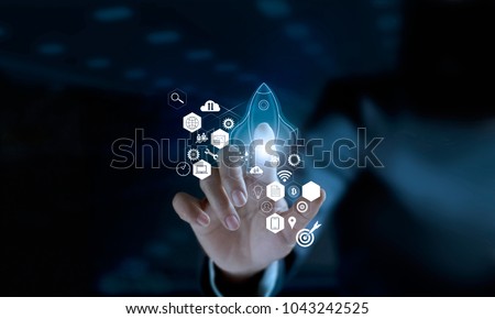 
Startup concept. Businessman touching icon transparent rocket is launching and flying out with icon network connection on modern virtual interface.