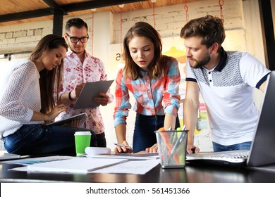 Startup Diversity Teamwork Brainstorming Meeting Concept.Business Team Coworkers Sharing World Economy Report Document Laptop.People Working Planning Start Up.Group Young Hipsters Discussing Cafe - Shutterstock ID 561451366