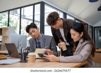 Startup employees analyzing data and sharing feedback in a modern co-working space.