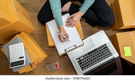 Startup Entrepreneurship Small Business Freelance SME Young lady portrait working at home office online laptop box Marketing Packaging Shipping E-commerce concept Side view