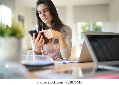 Startup girl working in office and using smartphone