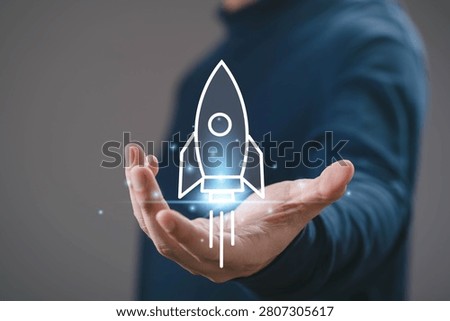 Startup launch concept with rocket icon rising from hand, innovation and business growth idea. New project development, success strategy, digital transformation and entrepreneurial vision.