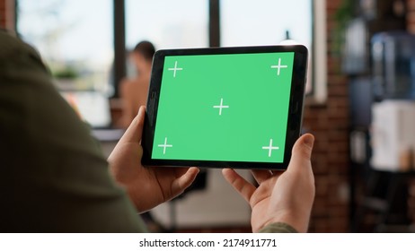 Startup manager looking at horizontal greenscreen on digital tablet, working with blank copyspace template and mockup display. Using isolated chroma key background on gadget. Close up. - Shutterstock ID 2174911771