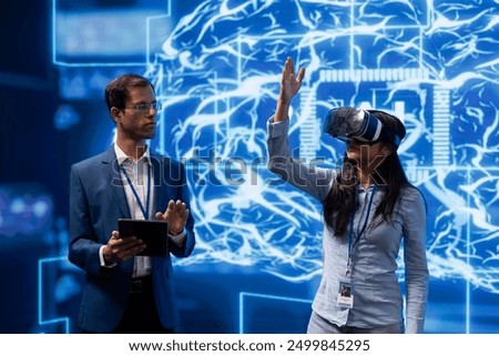 Startup manager using conference as platform to present latest AI and VR headsets products. IT specialists at summit showing investors virtual reality and augmented reality tech