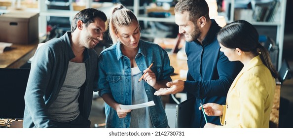 Startup And Millenial Business Concept. Group Of Managers Discussing Team Tasks At The Office