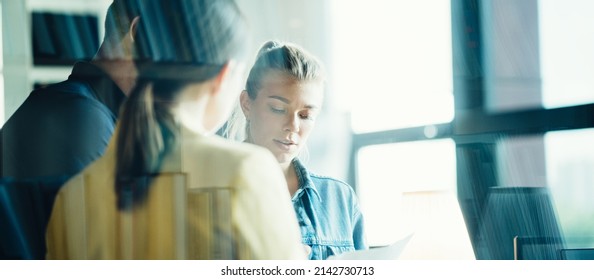 Startup And Millenial Business Concept. Woman Manager Explaining Tasks To Her Work Team