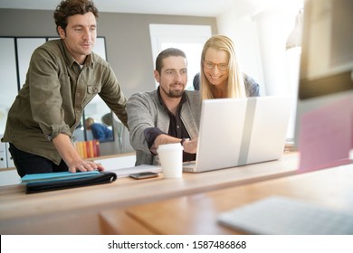 Startup people meeting in co-working area to talk about project - Shutterstock ID 1587486868