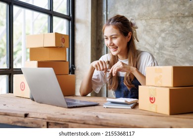 Startup Small Business Entrepreneur SME, Young Asian Girl Receive The Order On Phone And Laptop At Home Office, Small Business Online Sell Marketing Delivery, SME E-commerce Telemarketing Concept