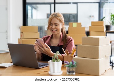 Startup Small Business Entrepreneur SME Freelance Woman Work With Mobile Phone, Young Asian Owner Use Computer, Online Market Packing Box Delivery, SME E-commerce Telemarketing Concept