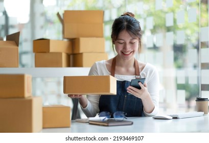 Startup Small Business Entrepreneur SME, Asian Woman Receive Order On Phone. Portrait Young Asian Small Business Owner Home Office, Online Sell Marketing Delivery, SME E-commerce Telemarketing Concept