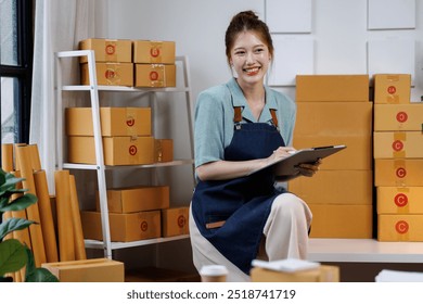 Startup small business entrepreneur SME, asian woman receive order on laptop,clipboard. Success young Asian small business owner online sell marketing delivery, SME e-commerce telemarketing concept - Powered by Shutterstock