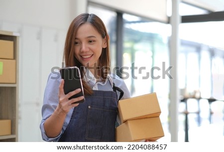Startup small business entrepreneur SME, asian woman receive order on phone. Portrait young Asian small business owner home office, online sell marketing delivery SME e-commerce telemarketing concept