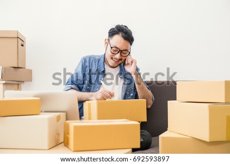 startup small business entrepreneur SME freelance man working with box, Young Asian small business owner office online market packing box delivery, SME delivery e-commerce telemarketing seller concept ストックフォト © 