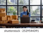 Startup small business SME, Entrepreneur owner asian woman taking receive and checking online purchase shopping order to preparing pack product box SME sellers concept, 