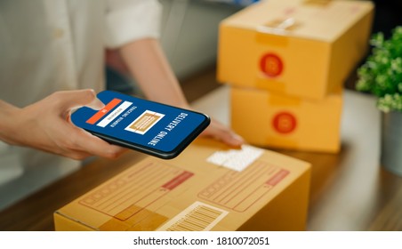 Startup Small Business, Woman Owner Using The Smartphone Scan The Barcode To Save Information Into The Shipping System And Packing Box Delivery Products To Customers From Online Ordering.