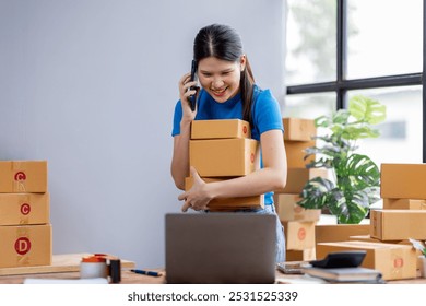 Startup SME small business entrepreneur SME or freelance Asian woman calling phone, online marketing packaging box and delivery, SME concept
 - Powered by Shutterstock