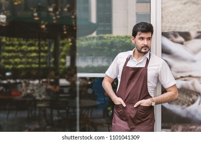 Startup Successful Small Business Owner Man Walking In His Coffee Shop Or Restaurant. Portrait Of Young Caucasian Man Successful Barista Cafe Owner