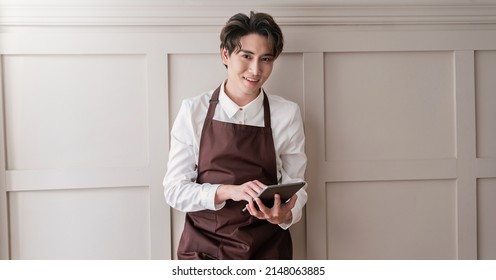 Startup Successful Small Business Owner Man Sme, Handsome Men In Coffee Shop Restaurant. Portrait Of Young Asian Barista Cafe Local Owner Hold Gadget. SME Sell Online Delivery Entrepreneur Business 