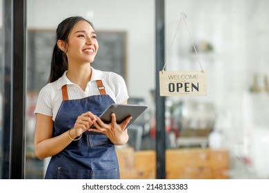 Startup successful small business owner sme beauty girl stand with tablet smartphone in coffee shop restaurant. Portrait of asian tan woman barista cafe owner. SME entrepreneur seller business concept - Shutterstock ID 2148133383