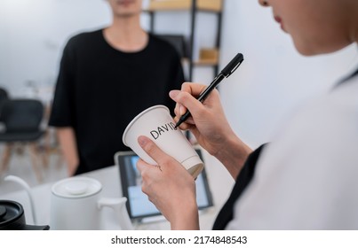 Startup successful small business owner sme woman, beauty girl white name on paper cup in coffee shop restaurant. Portrait of asian woman barista cafe owner. SME entrepreneur niche market seller