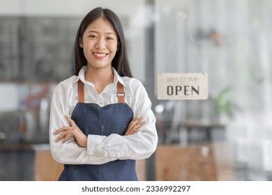 Startup successful small business owner sme beauty girl stand with tablet smartphone in coffee shop restaurant. Portrait of asian tan woman barista cafe owner. SME entrepreneur seller business concept - Powered by Shutterstock