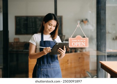 Startup successful small business owner sme woman stand with tablet  in cafe restaurant. woman barista cafe owner.  - Powered by Shutterstock