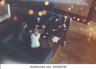 Startup Team. Meeting On The Couch. Big Open Space Office. Five People. Intentional Lens Flares