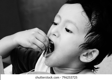 Starving Street Kids Eating Noodles In Black And White Colour Tone