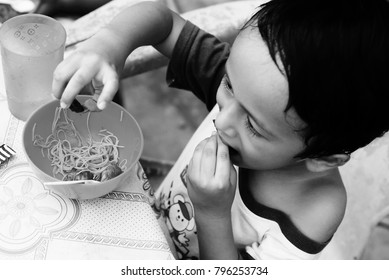 Starving Street Kids Eating Noodles In Black And White Colour Tone