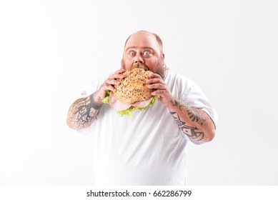 Starving Thick Man Biting Large Burger