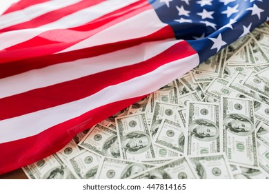 State Budget, Finance And Nationalism Concept - Close Up Of American Flag And Dollar Cash Money