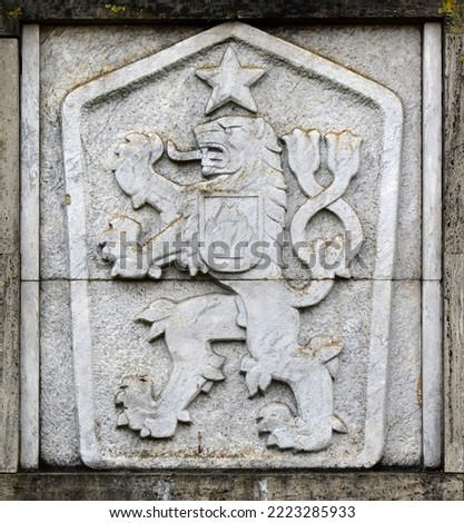 State emblem, symbol of communist Czechoslovakia, a two-tailed lion with a five-pointed star, Hussite shield in the background. Сток-фото © 