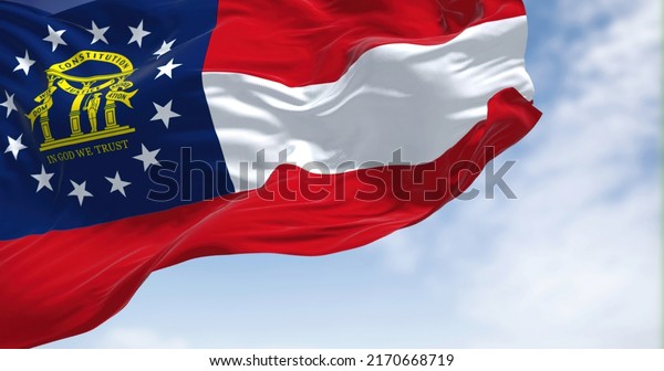 The state flag of Georgia waving in the\
wind. Georgia is a state in the Southeastern region of the United\
States. Democracy and\
independence.