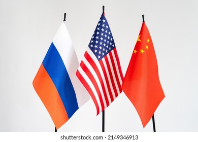 State Flags Of America, Russia, China On White Background. American Flag In Centre. Conflict Concept