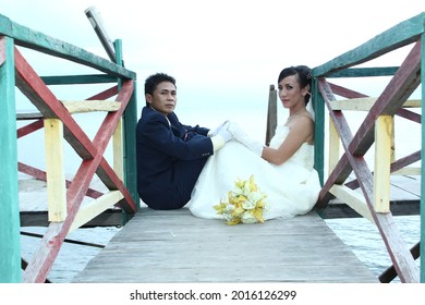 "State of Indonesia, Central Sulawesi Province, Poso Regency, North Pamona District, Tentena Village" "Poso Lake" October 15, 2010. Amazing smiling wedding couple. Beautiful bride and stylish groom